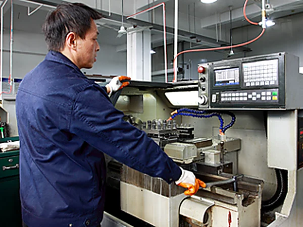 Operator setting up a CNC lathe